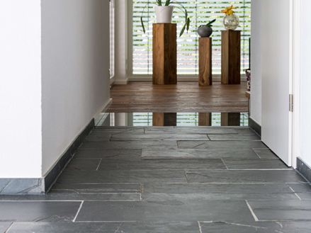 carrelage en ardoise, sol en bois et en verre avec plantes